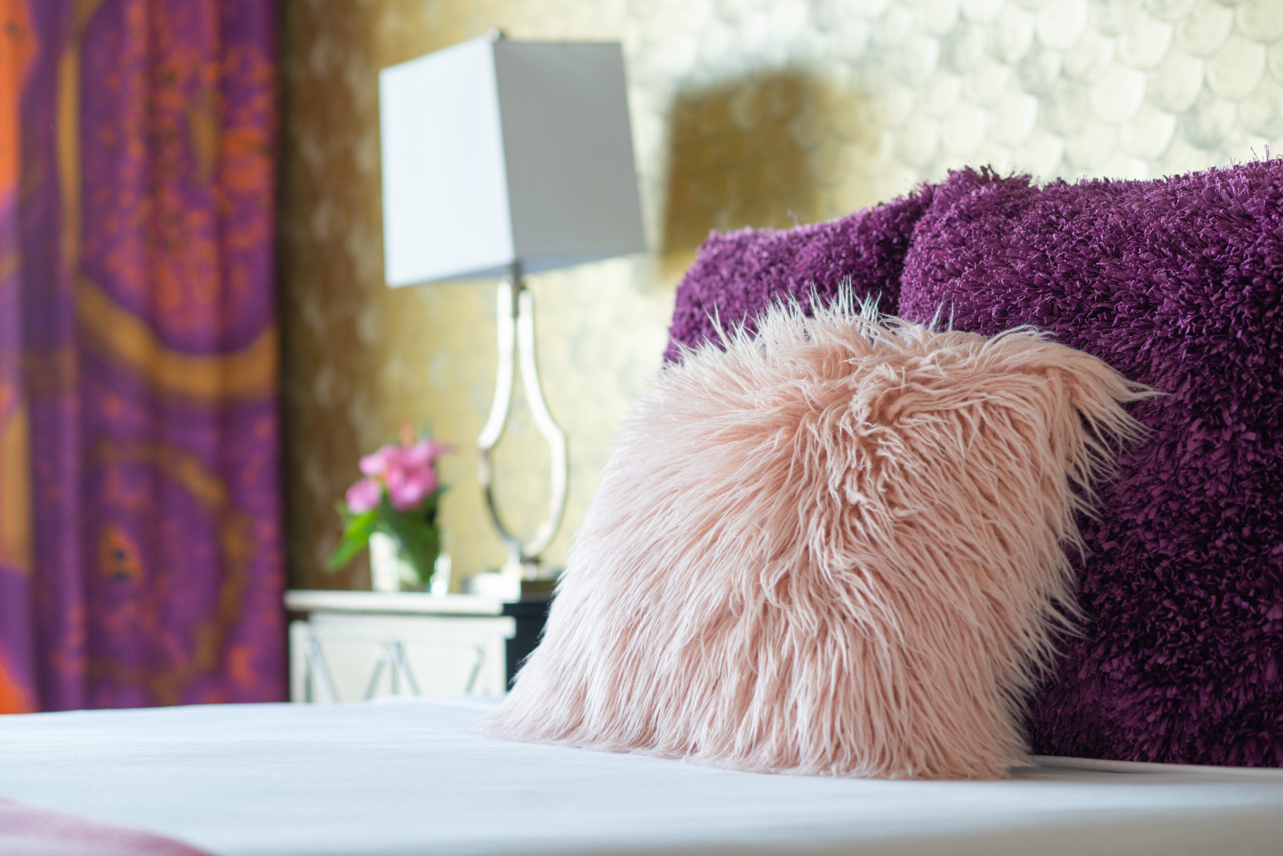 Purple and pink fuzzy pillows.