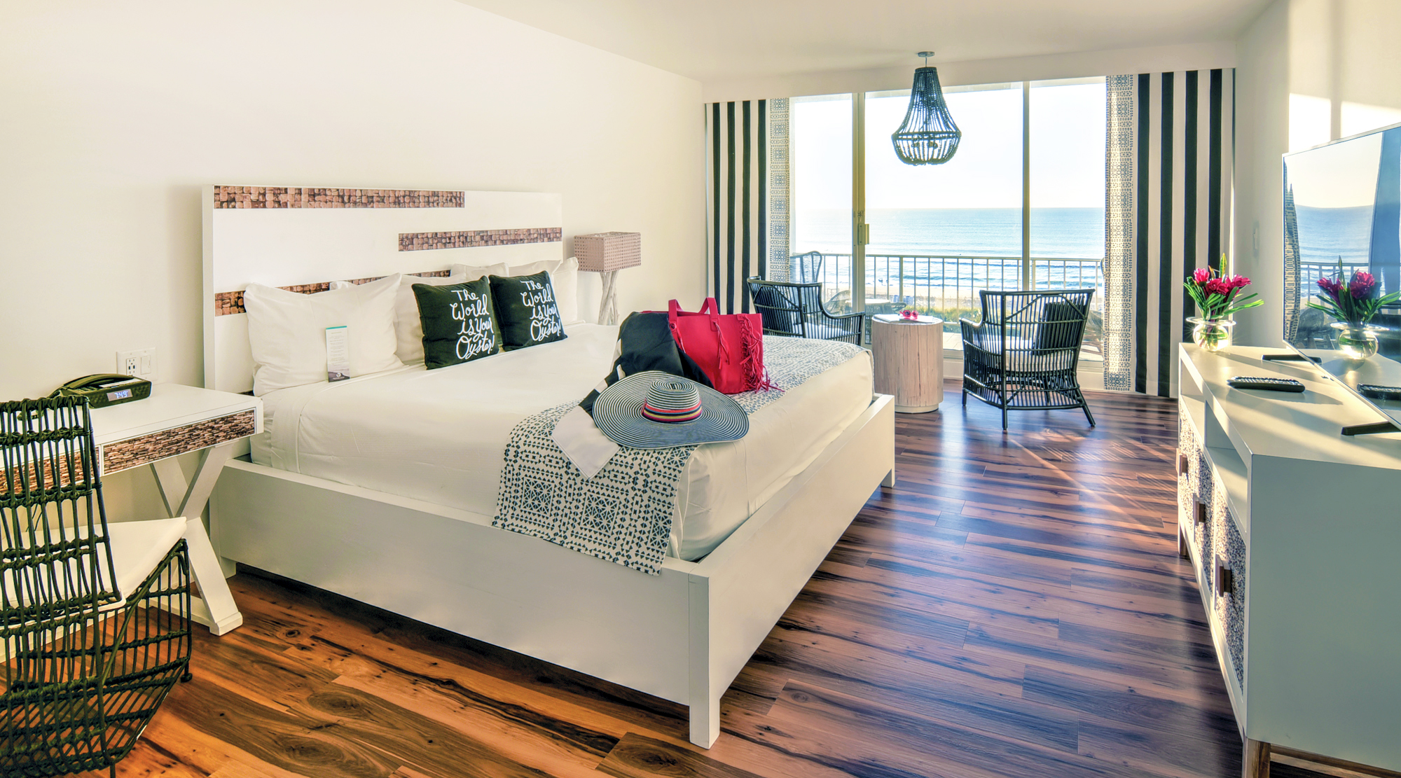 Oceanfront guest room with hardwood floor and outdoor balcony.