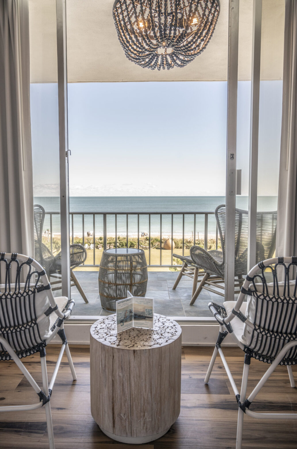 Oceanfront outdoor balcony and seating in hotel room at Blockade Runner resort.