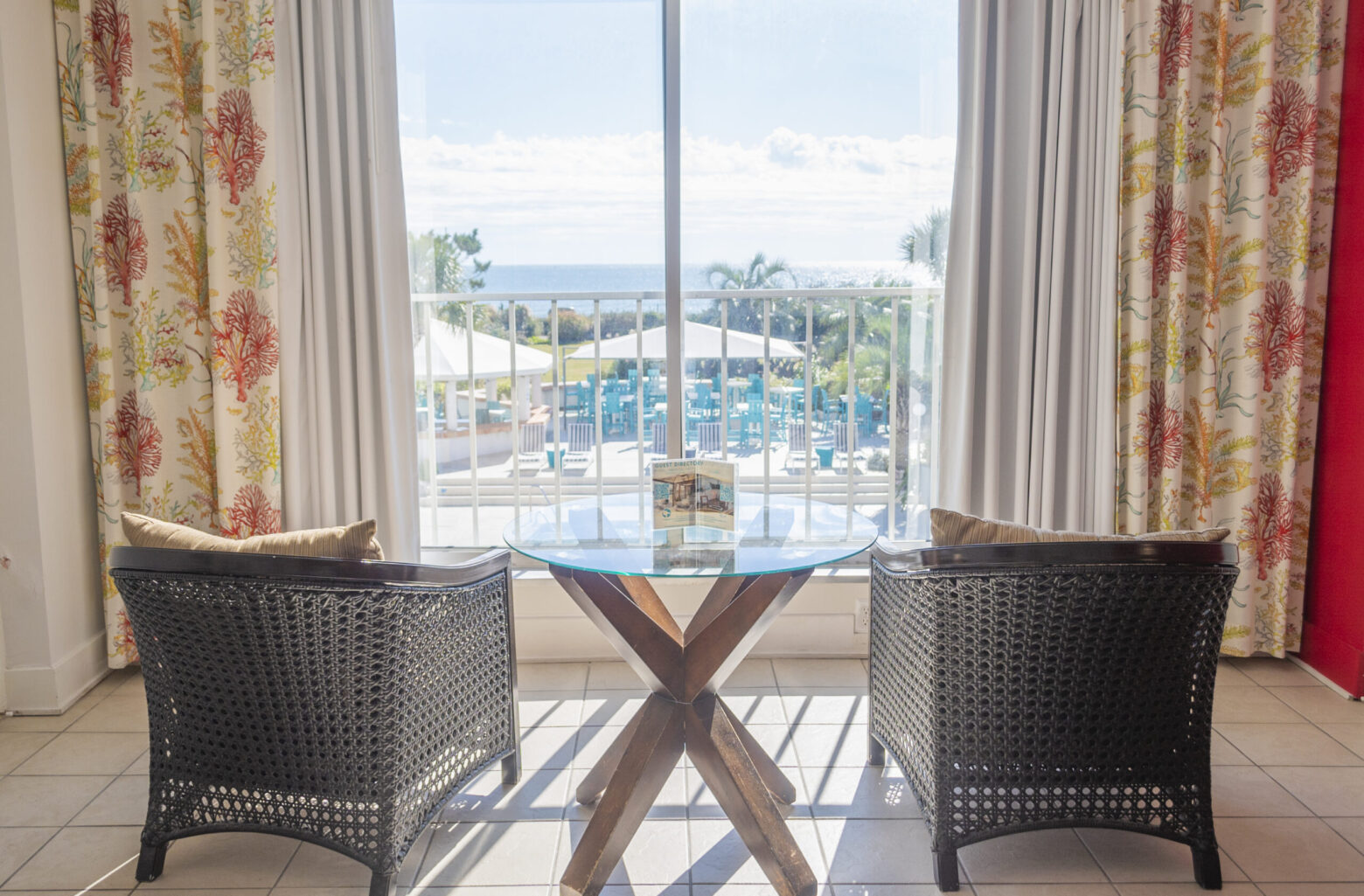 Oceanfront room wicker chairs with pool view at Blockade Runner.