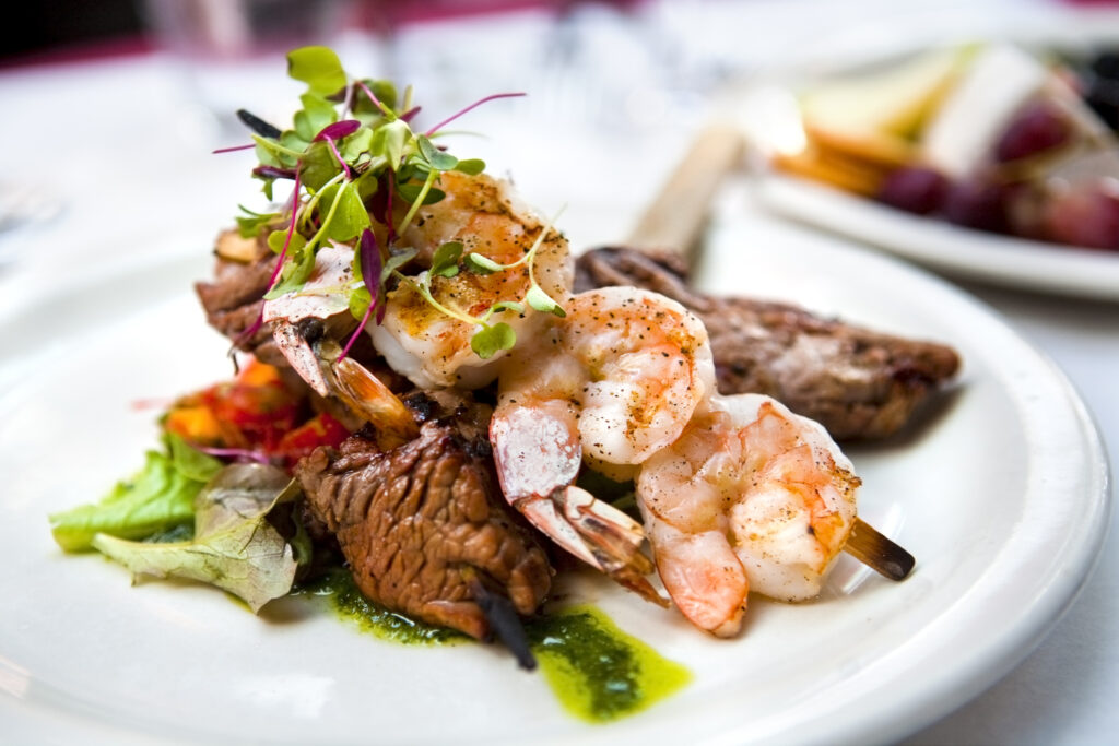 A elegantly presented plate of shrimp and beef skewers at wrightsville beach restaurant.